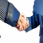 31194187-businessmen-hand-shake-together-with-modern-city-building