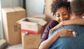 Young,African,Woman,Holding,Home,Keys,While,Hugging,Boyfriend,In